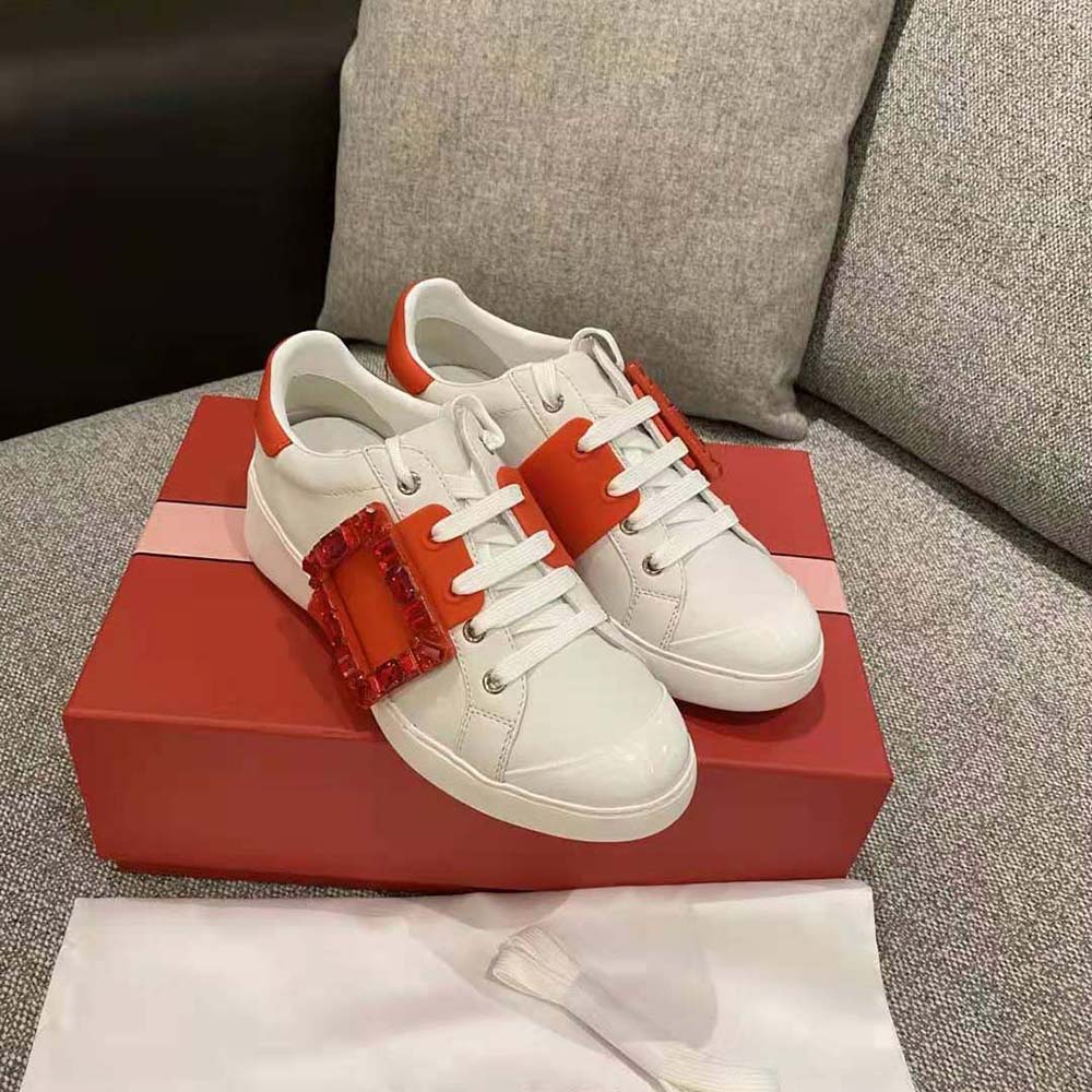 Close-up of striking Strass buckle on Roger Vivier red leather sneakers