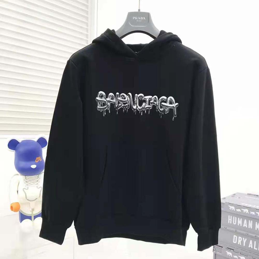 Close-up on embroidered Balenciaga logo on black heavy fleece hoodie