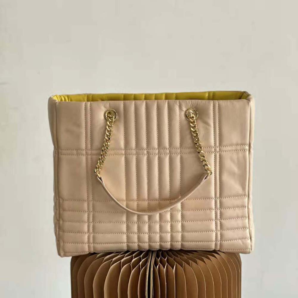 Side angle showing silhouette and sandy colour of Burberry Medium Lola Shopper Bag