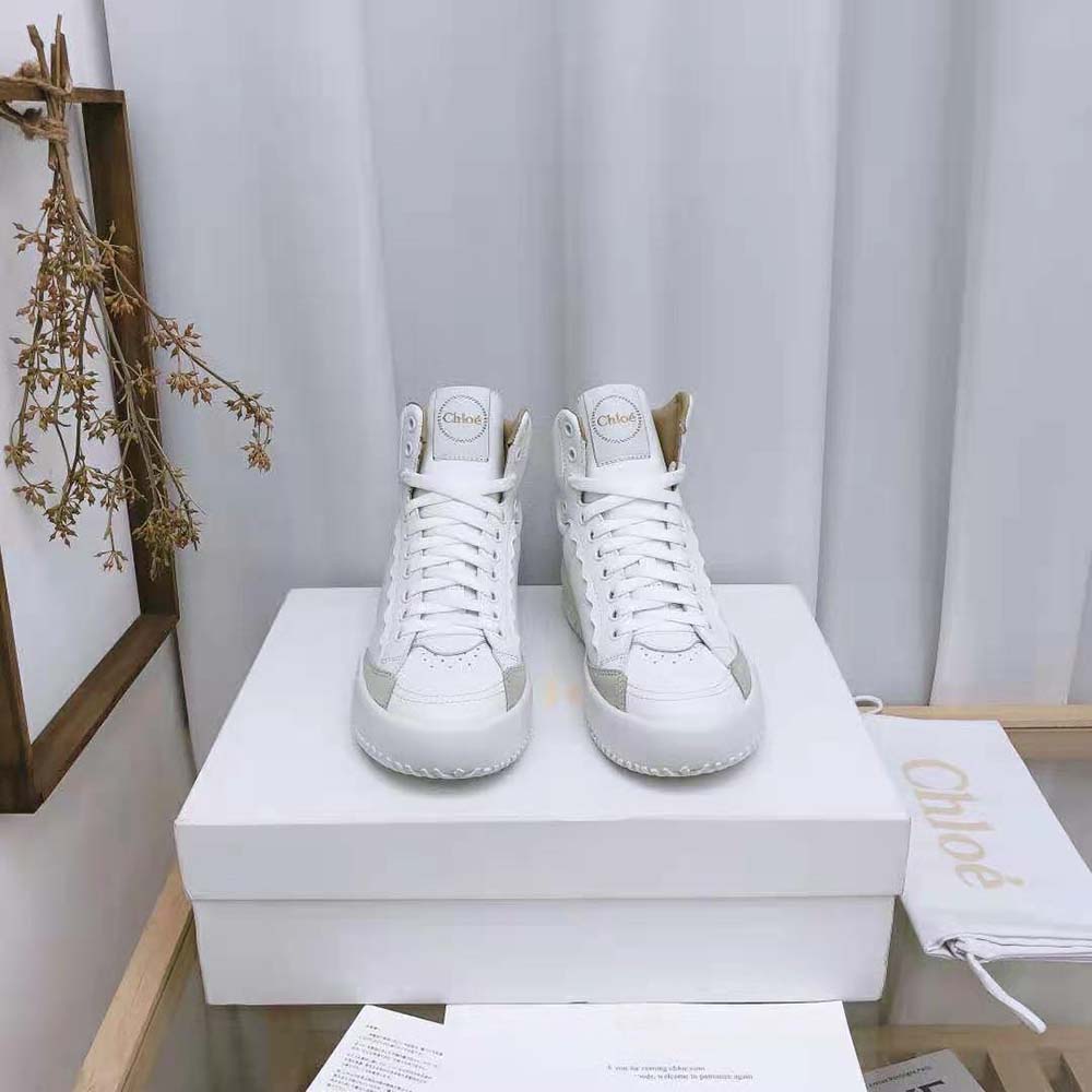 Close-up of white leather and embossed logo on Chloe Women Franckie sneaker