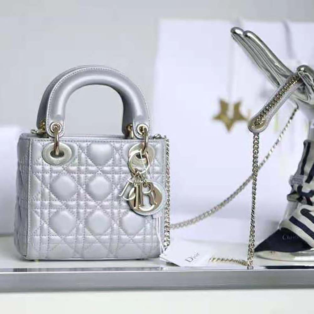 Close-up of silver-tone ‘D.I.O.R.’ charms on mini Lady Dior bag