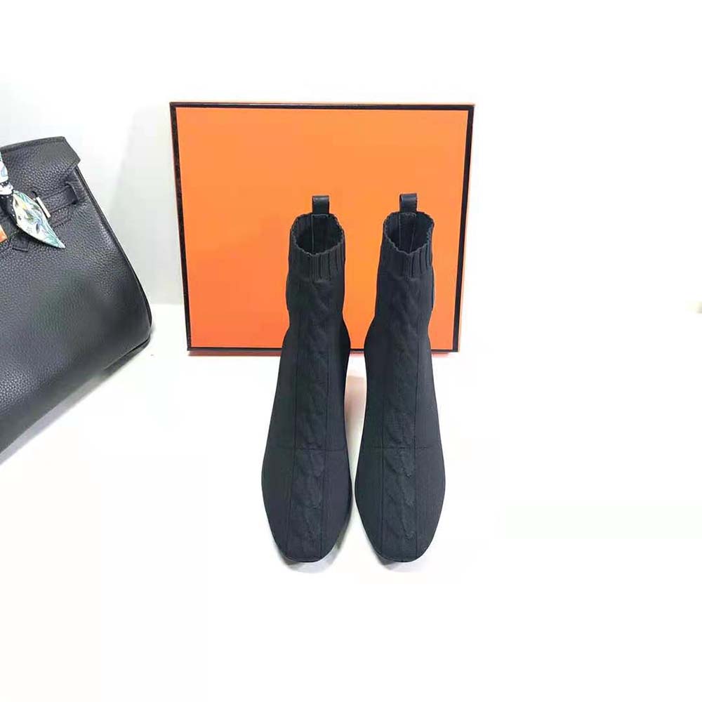 Close-up of Hermes embossed detail and zipper on ankle boot