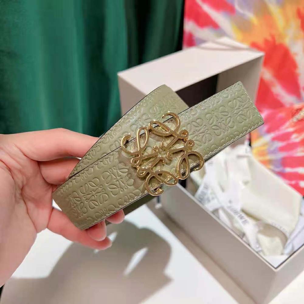 Close-up of Loewe Anagram embossed hardware on green silk calfskin belt