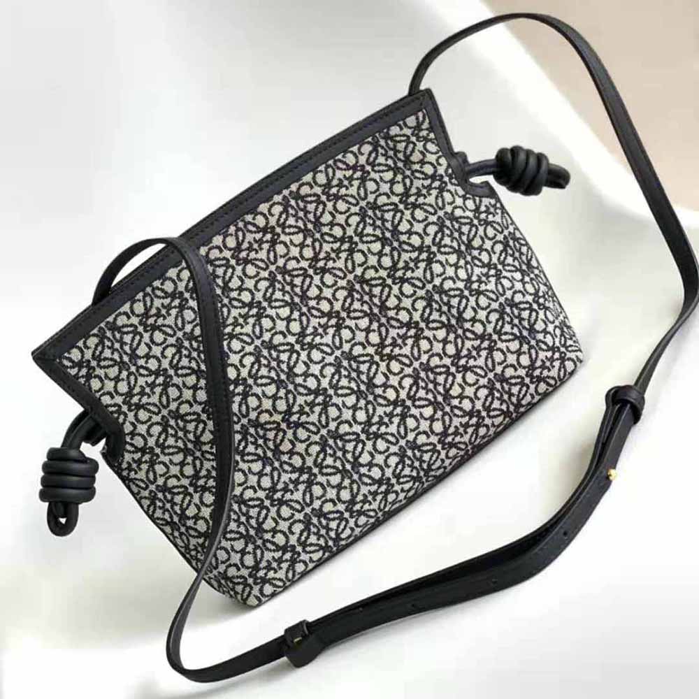 Side profile showing flap closure and calfskin texture of Loewe Mini Flamenco Clutch