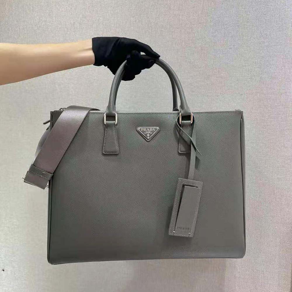 Close-up of signature Prada logo plaque on silver Galleria bag
