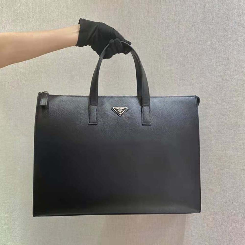 Close-up of Prada logo and silver hardware on black leather tote