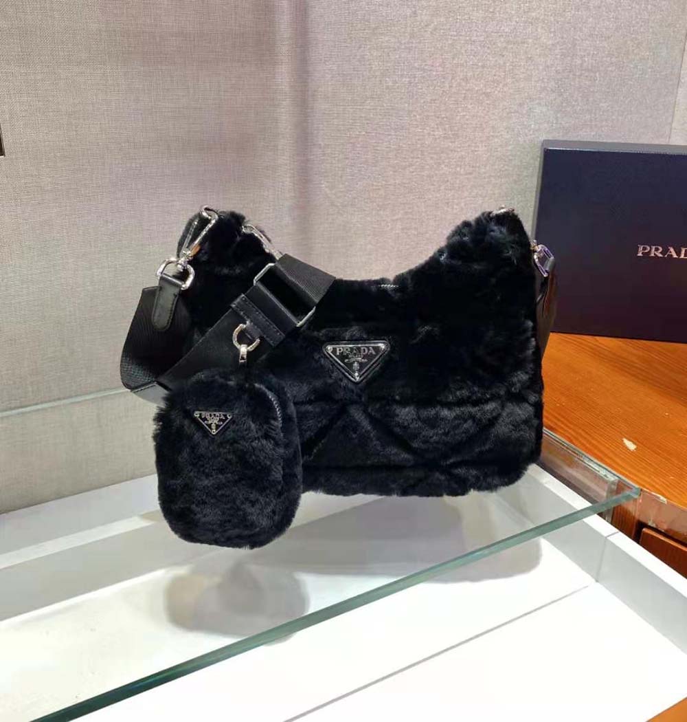 Side angle showcasing patchwork texture on Prada black shearling shoulder bag