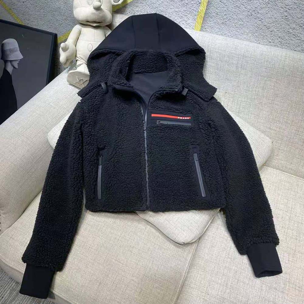 Close-up of Prada branded hardware on black recycled fleece jacket