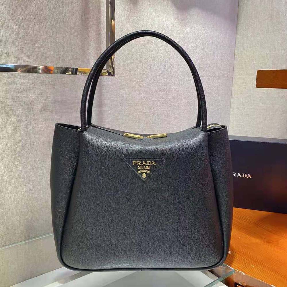 Side angle showing structured silhouette of Prada Women Medium Leather handbag