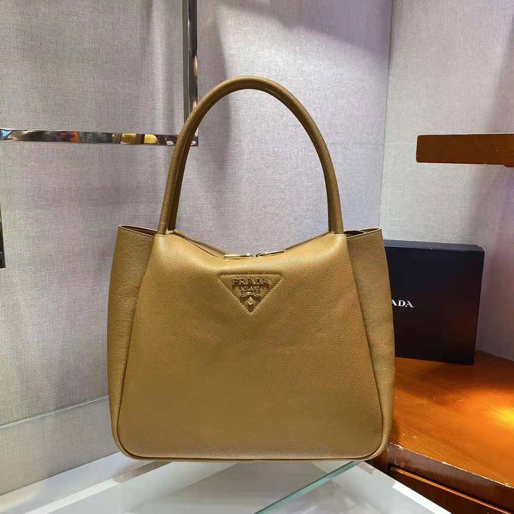Side angle of Prada Women Medium Leather handbag showing structured silhouette