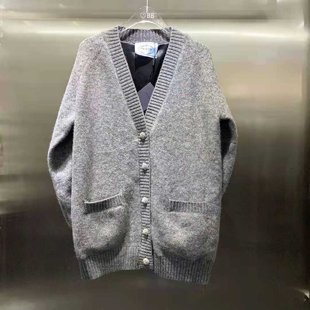 Close-up detail of Prada hardware on oversized wool cardigan