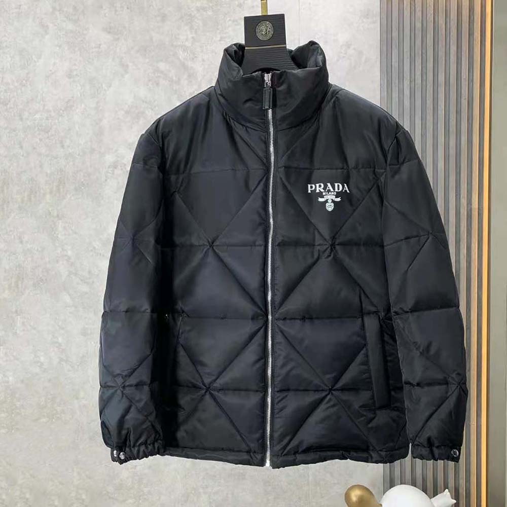Close-up of Prada logo plaque on the black Re-Nylon down jacket