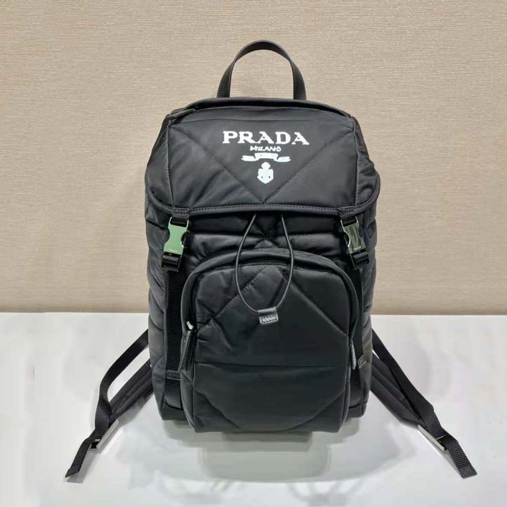 Close-up of silver hardware and Prada logo on backpack flap