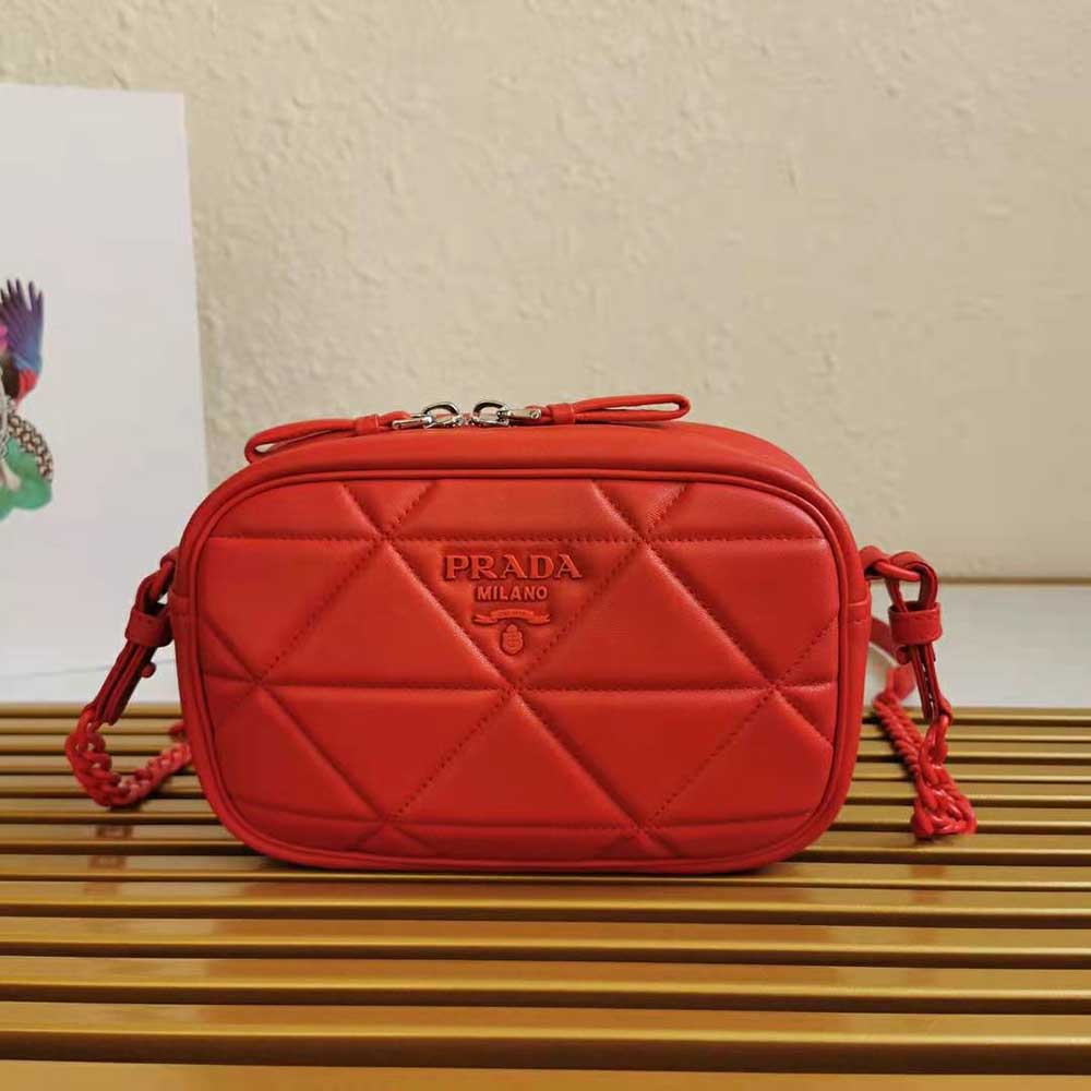 Close-up of gold-tone hardware on Prada Women Spectrum Shoulder Bag-Red
