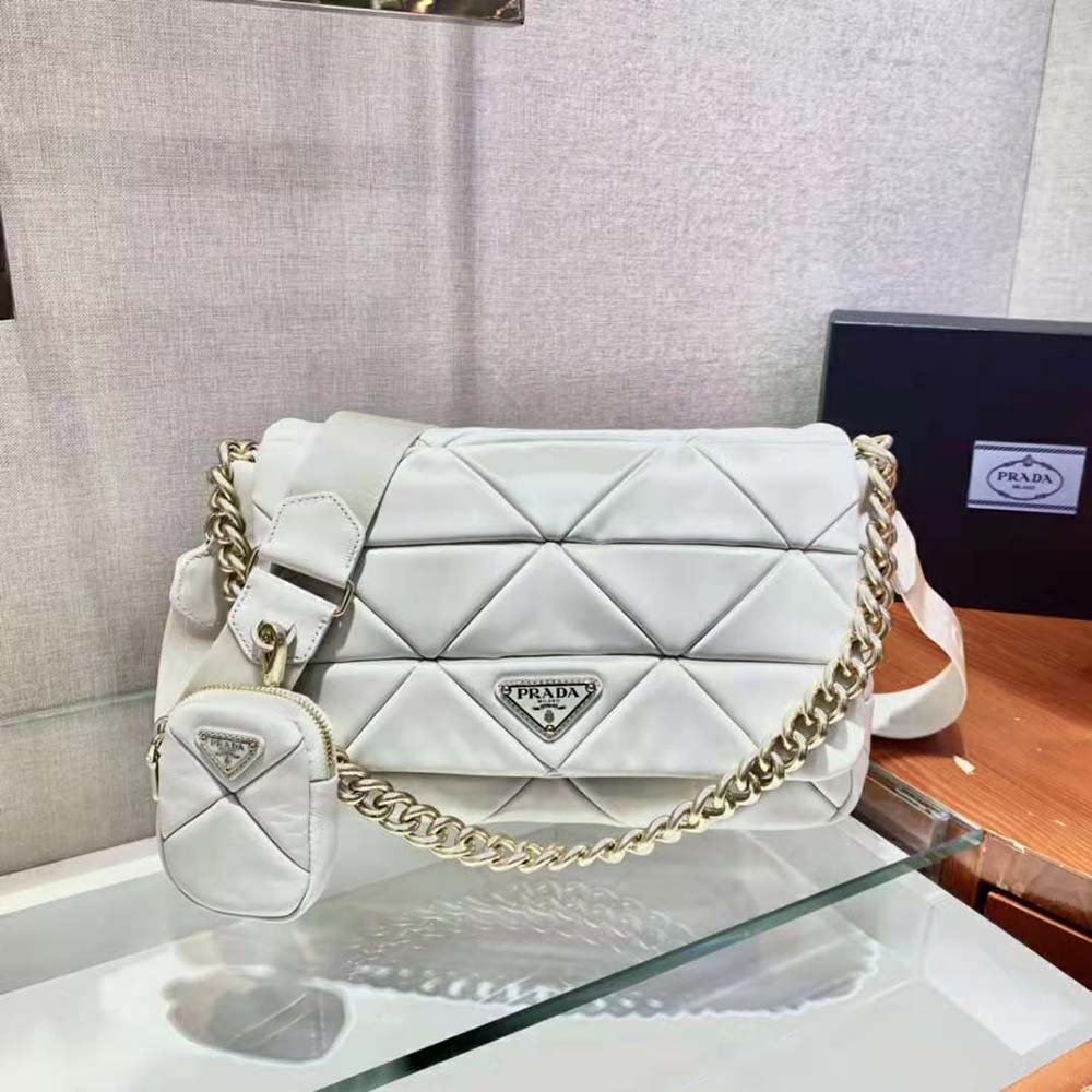 Close-up of patchwork detail and silver hardware on Prada bag