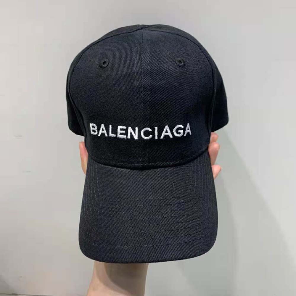 Close-up detail of embroidered Balenciaga logo on black baseball cap