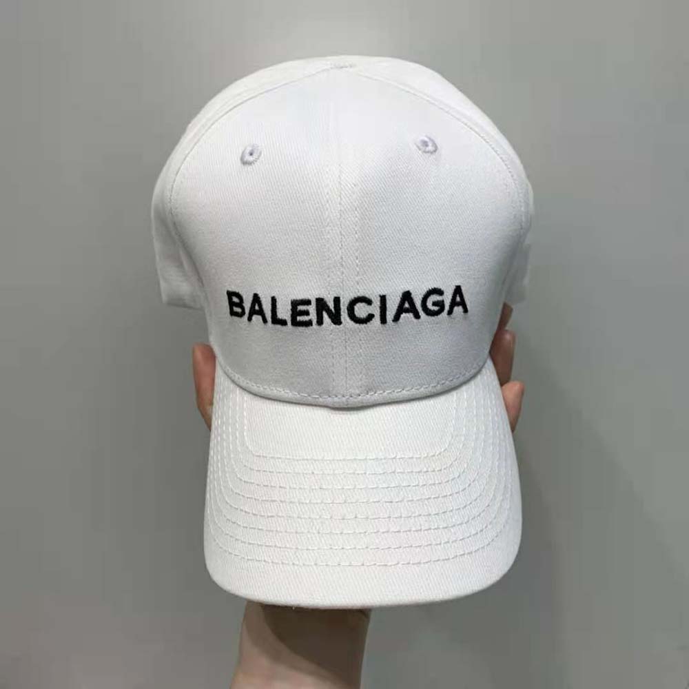 Close-up detail of black embroidered Balenciaga logo on white cap