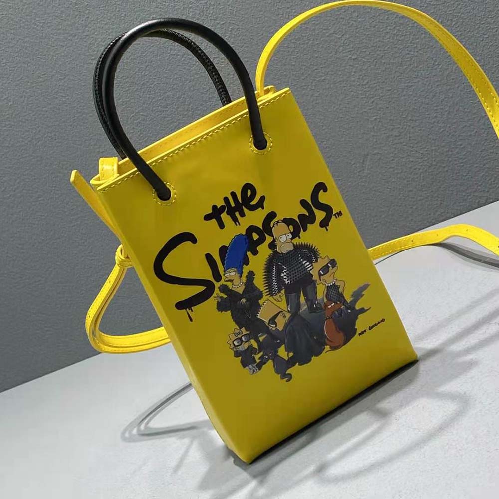 Side view highlighting compact silhouette of Balenciaga Simpsons mini shopping bag