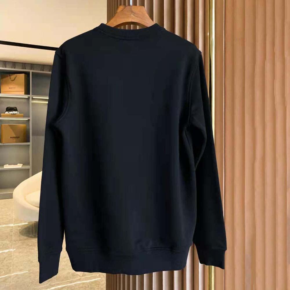 Side angle of Burberry Men Globe Graphic Cotton Sweatshirt-Black with ribbed cuffs