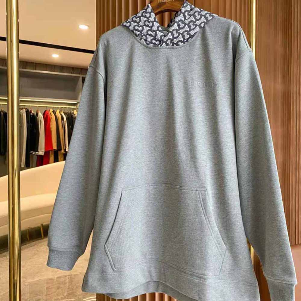 Close-up of Burberry monogram print detail on silver oversized hoodie