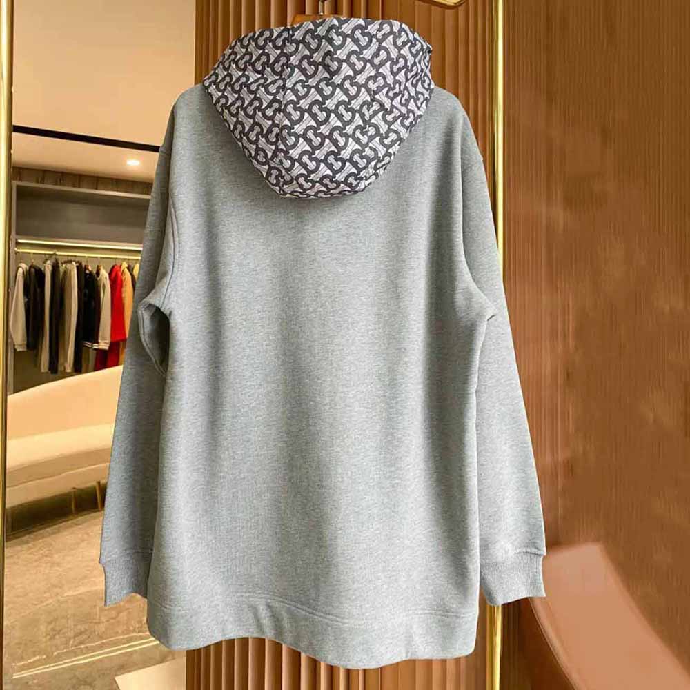 Side angle showing relaxed fit of Burberry Women Monogram Print Cotton Oversized Hoodie