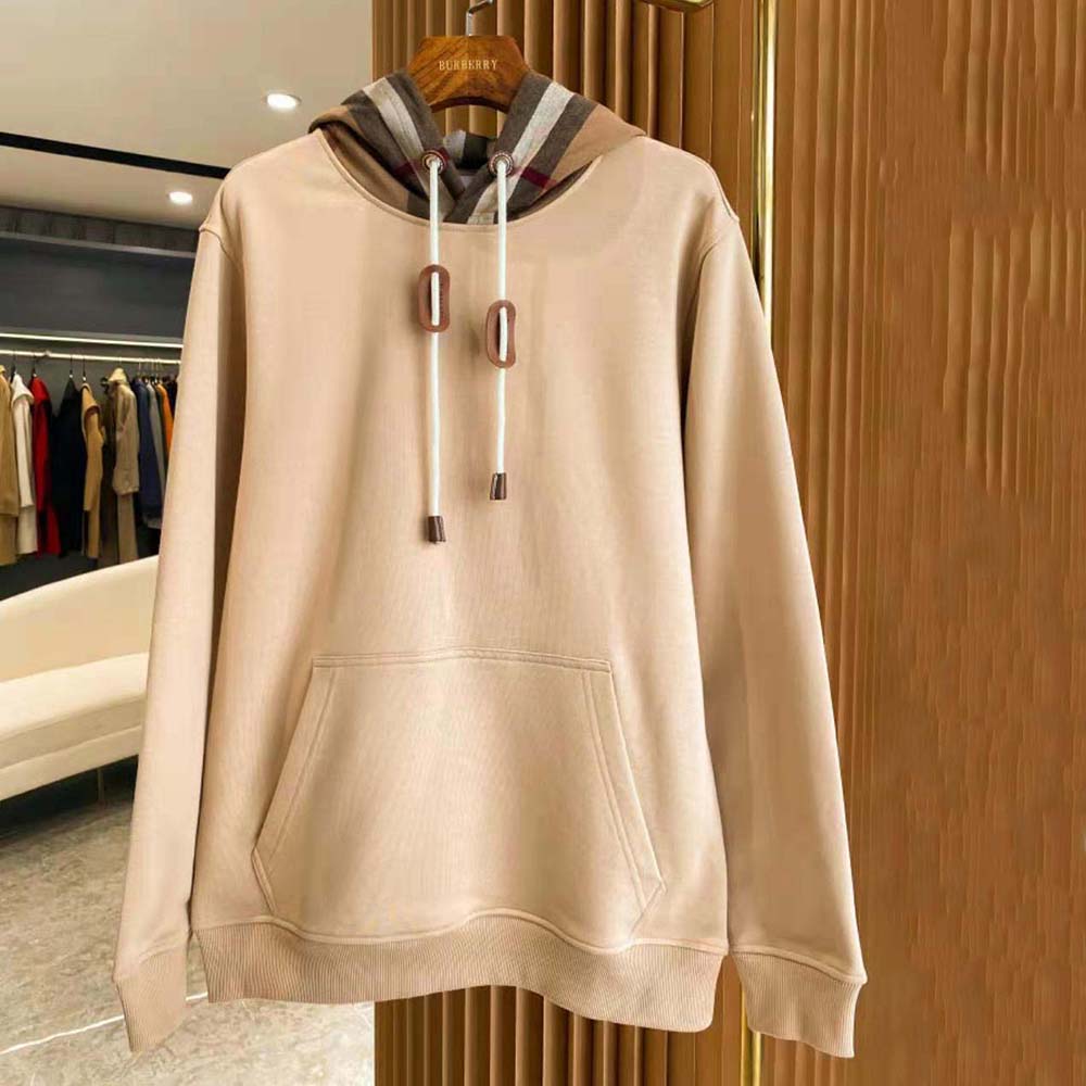 Close-up of brown cotton blend fabric and Burberry check on hoodie
