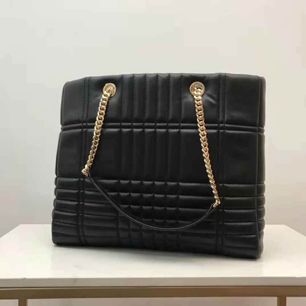 Side profile showcasing silhouette and zip closure of Burberry Lola Shopper Bag