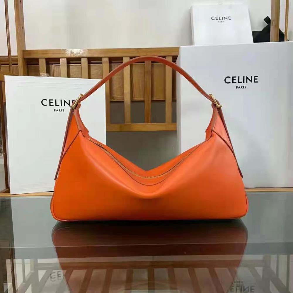Close-up detail of silver hardware on Celine Women Medium Romy orange bag