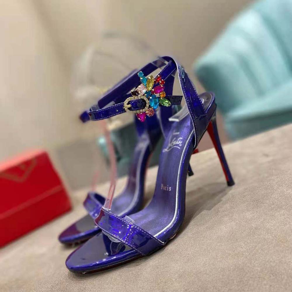 Close-up of purple leather straps and signature red sole on Goldie Joli sandal