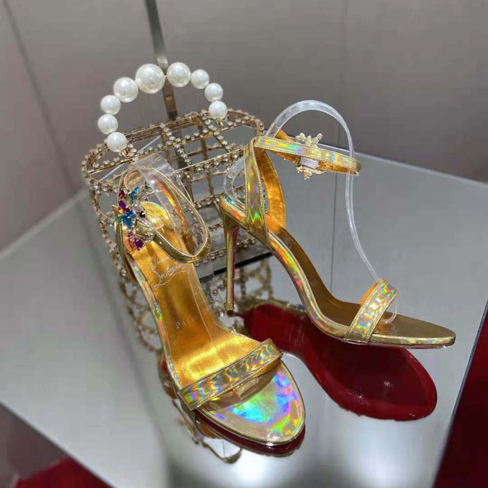 Close-up of yellow leather straps and red sole on Christian Louboutin Goldie Joli heels