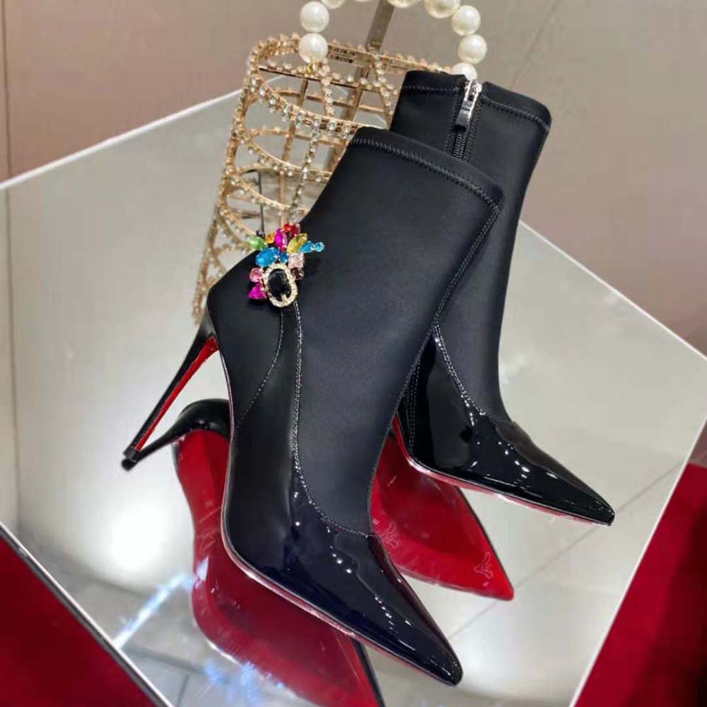 Close-up on signature red sole of Jessie Booty Joli black leather boot