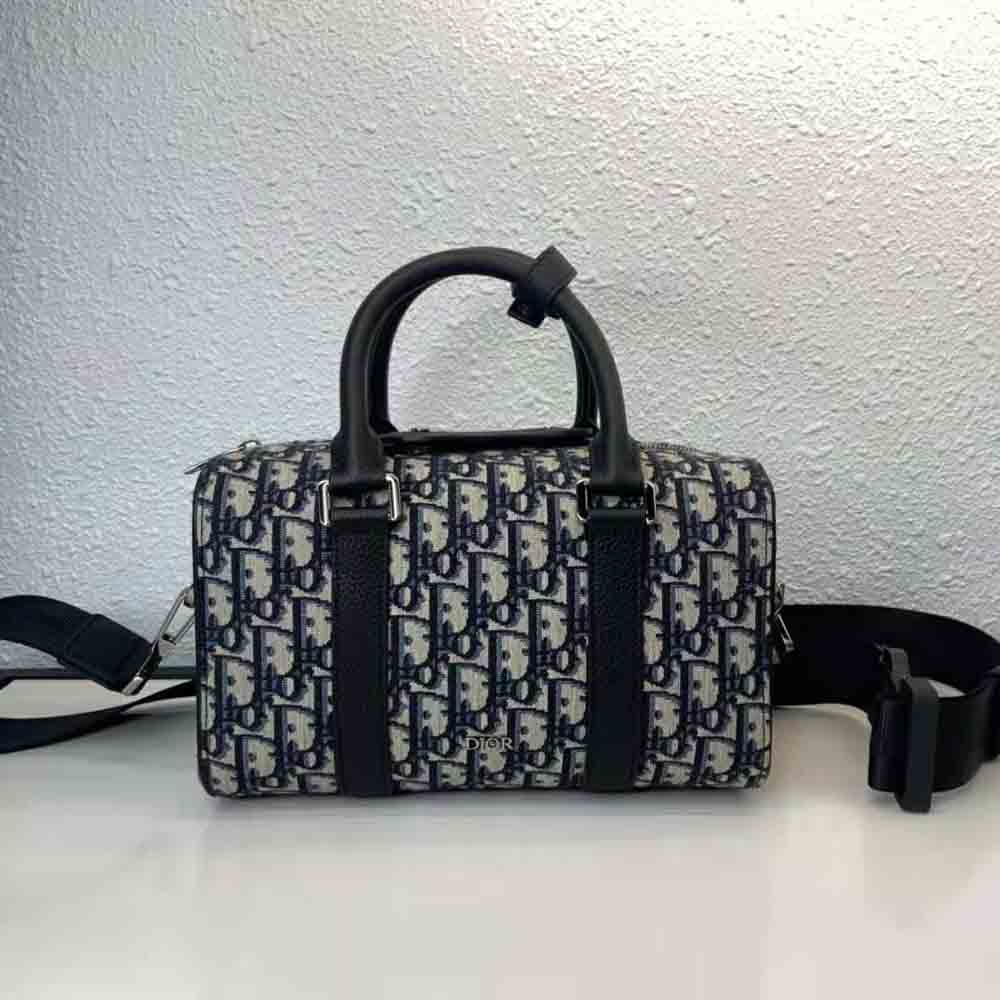 Close-up detail of blue jacquard fabric and silver hardware on Dior Men Lingot 26 Bag
