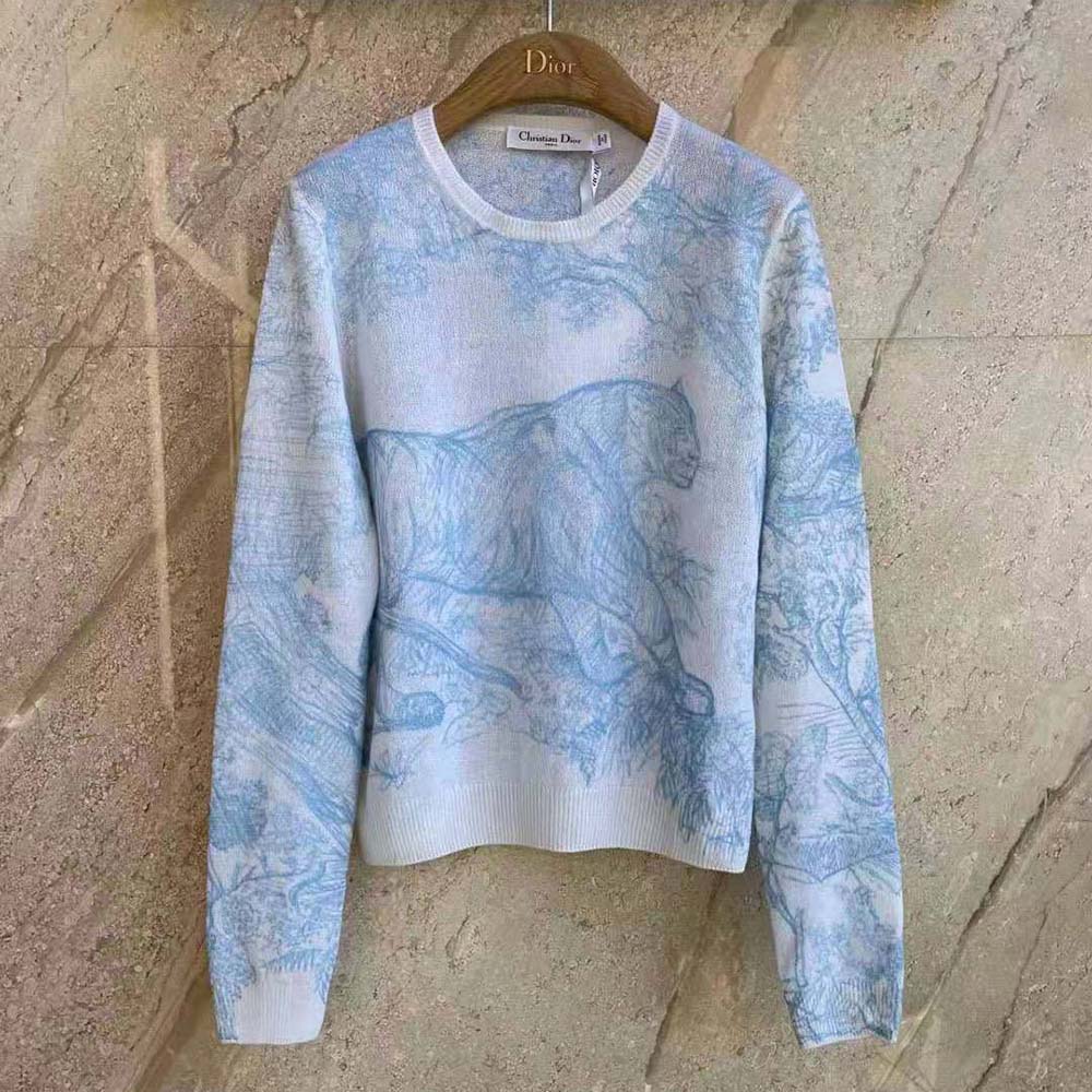 Close-up of embroidery and technical cashmere knit detail on sweater