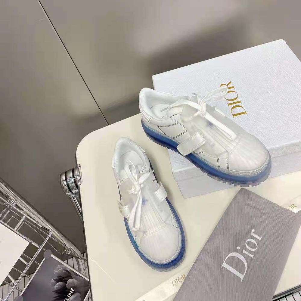 Top detail showing white calfskin and Dior-Id logo hardware on sneaker