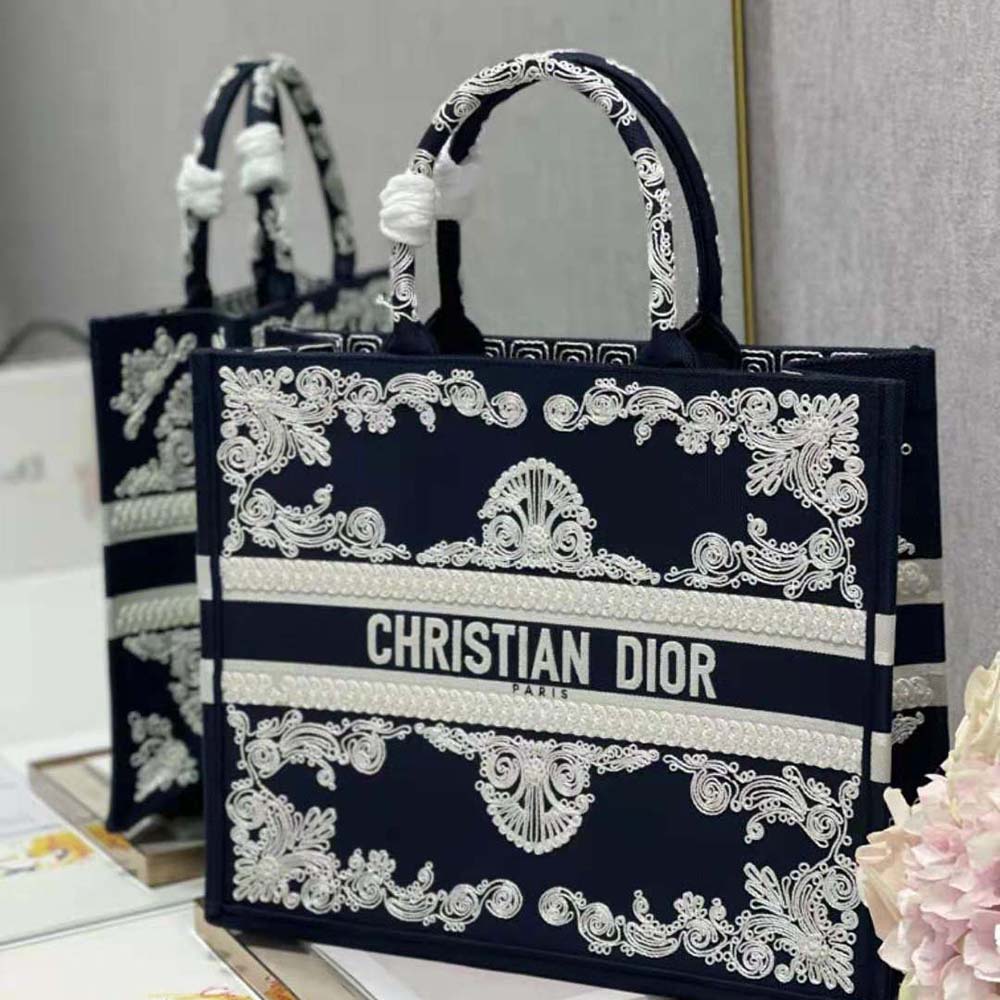 Side angle showing silver-tone hardware and structured silhouette of Dior Women Large Dior Book Tote