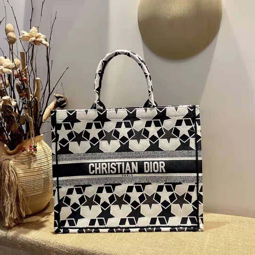 Close-up of white Dior Etoile embroidery on blue canvas tote