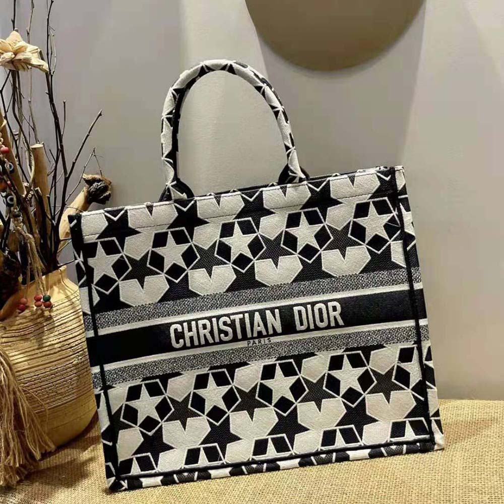 Side angle showing spacious interior and silver hardware on Dior tote