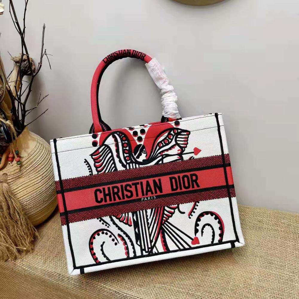 Side angle showing red canvas and gold-tone hardware on Dior Women Medium Dior Book Tote