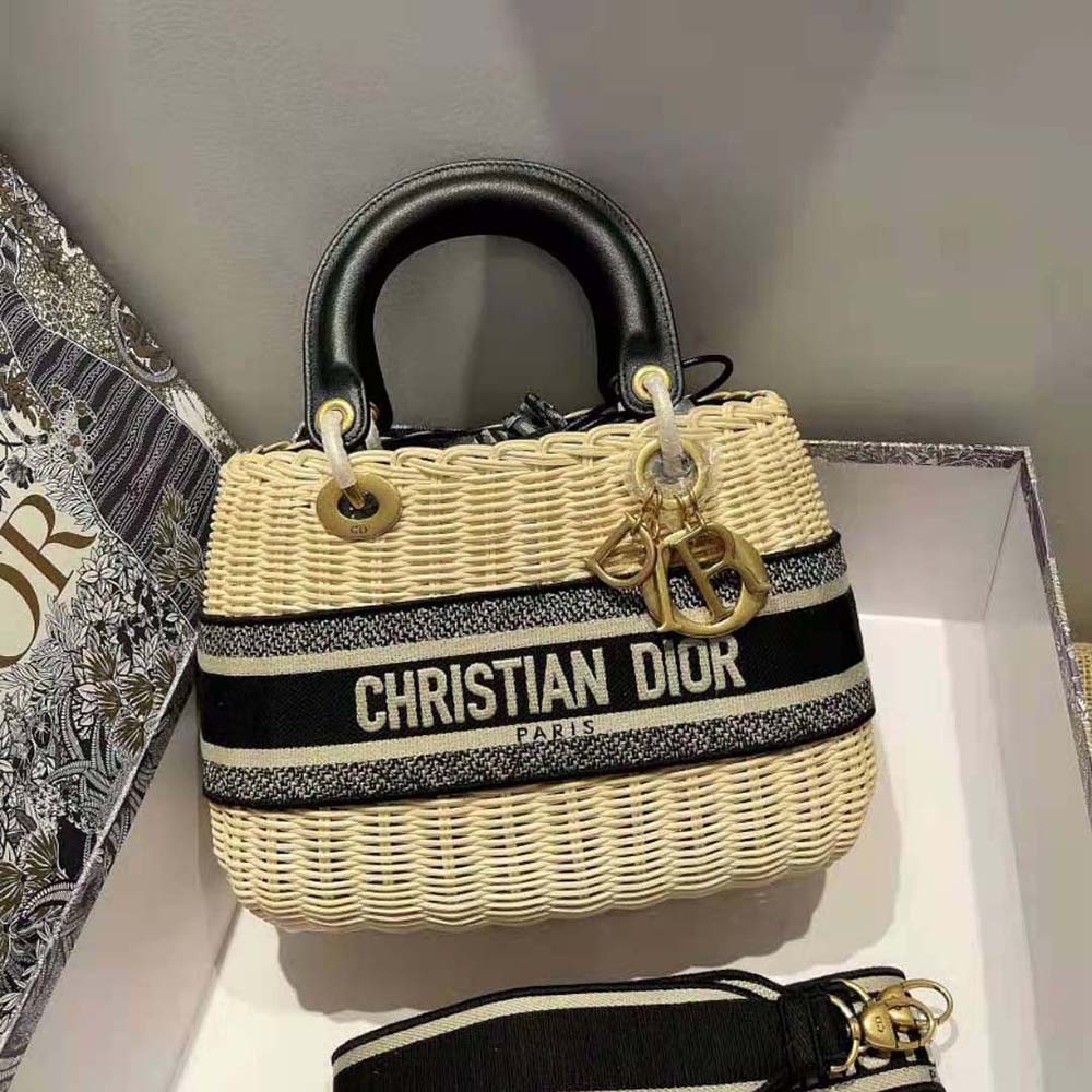 Detail of silver Dior charm and navy jacquard fabric on Lady Dior Bag