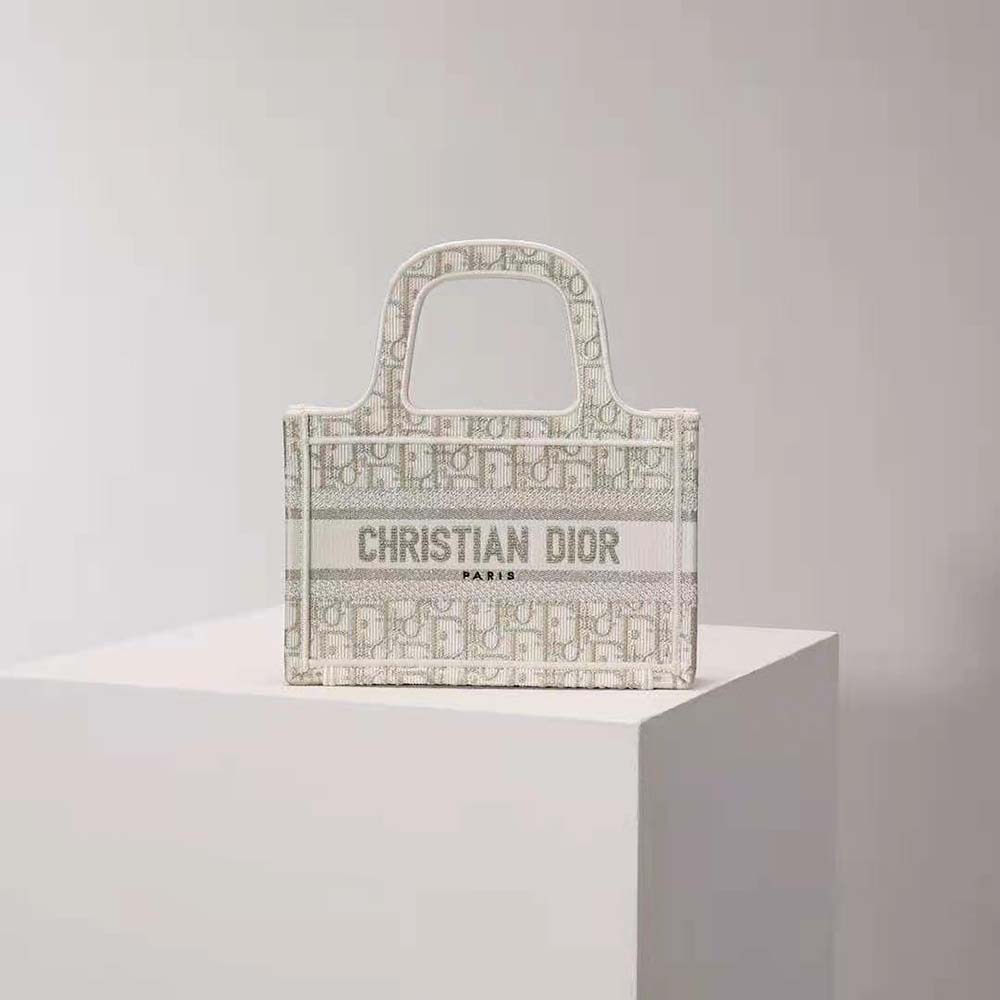 Close-up of gold-tone hardware on Mini Dior Book Tote with Dior Oblique embroidery