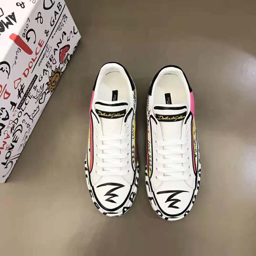 Close-up on gold D&G logo hardware on pink Portofino sneakers