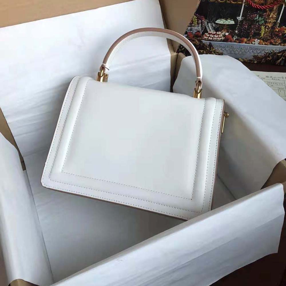 Side angle showing smooth calfskin texture and compact silhouette