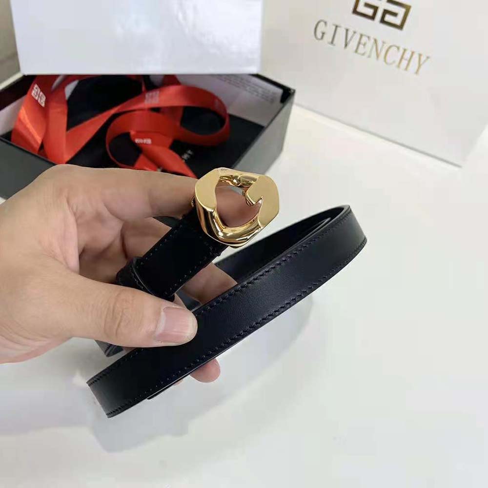 Close-up detail of gold G chain buckle on Givenchy reversible leather belt