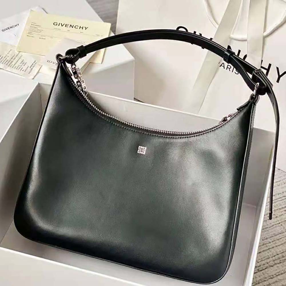Side angle showing adjustable leather strap of Givenchy Medium Moon Cut Out Bag