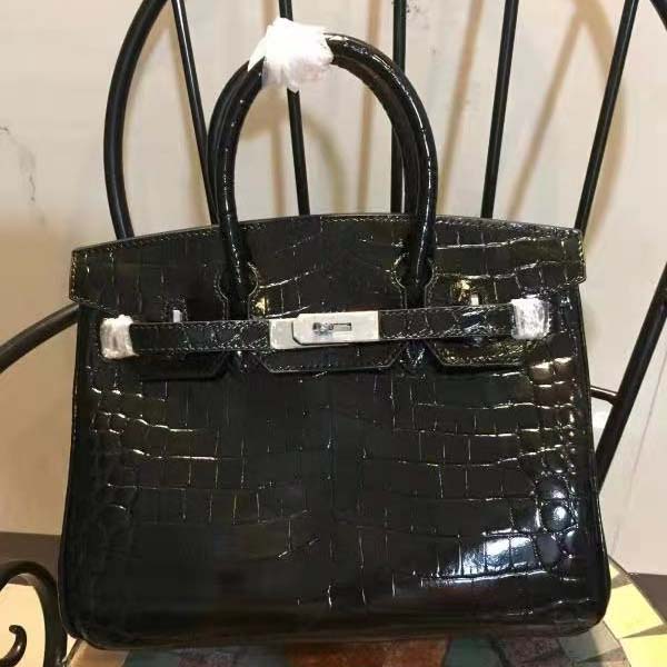 Close-up of gold hardware clasp on Hermes Birkin 30 Bag in black alligator leather