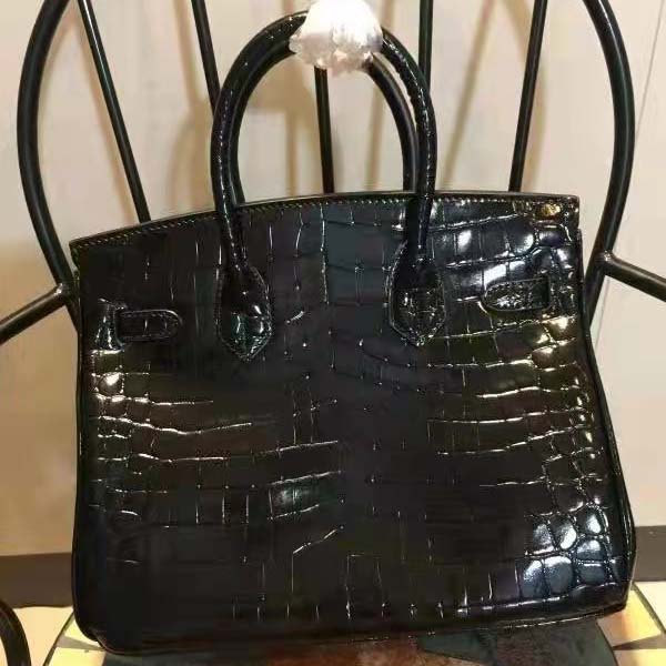 Side profile highlighting structured silhouette of Hermes Birkin 30 Bag in black alligator