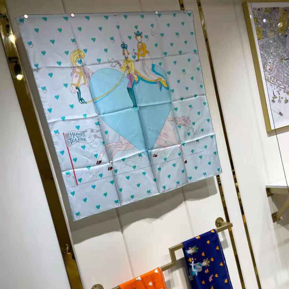 Woman styling Hermes Women Tea Time Scarf 70 tied around neck