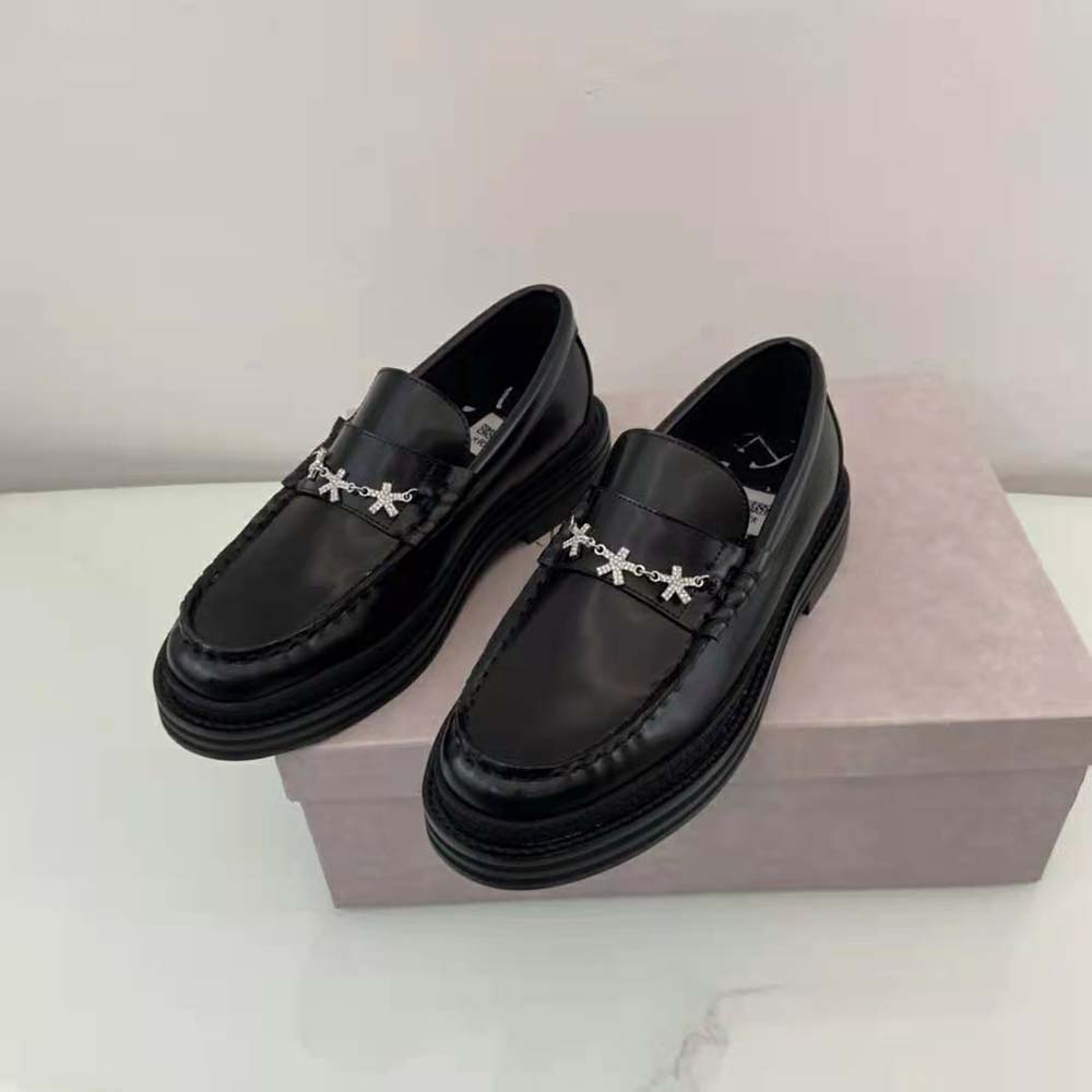 Close-up of Eric Haze star chain detail on Jimmy Choo loafers