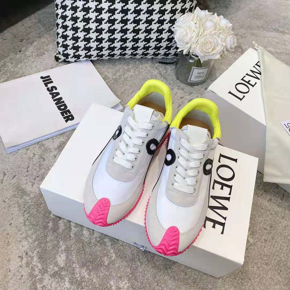 Close-up on pink suede detail and embossed Loewe logo on sneaker