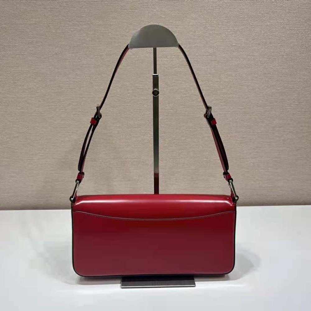 Side angle showing adjustable strap and compact shape of Prada Femme Bag-Red